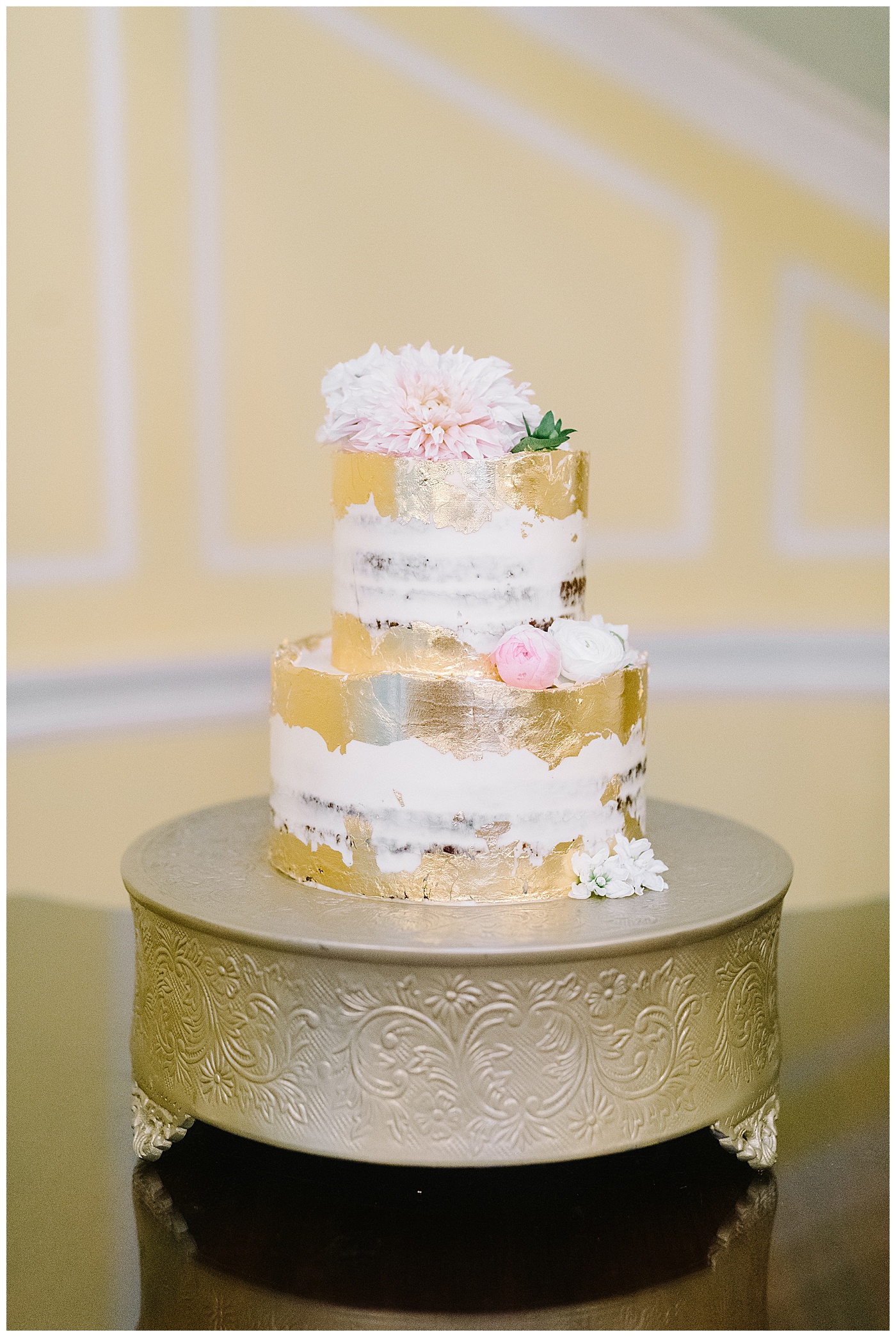 gold, white, and pink wedding cake