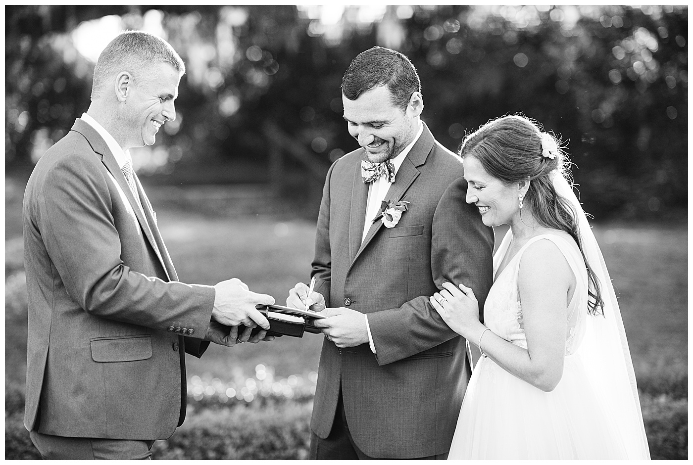 bride and groom signing marriage license