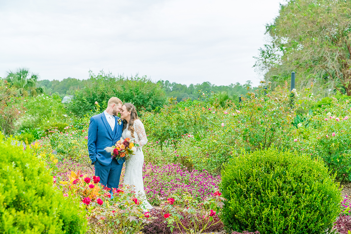 bride and groom amid fall garden